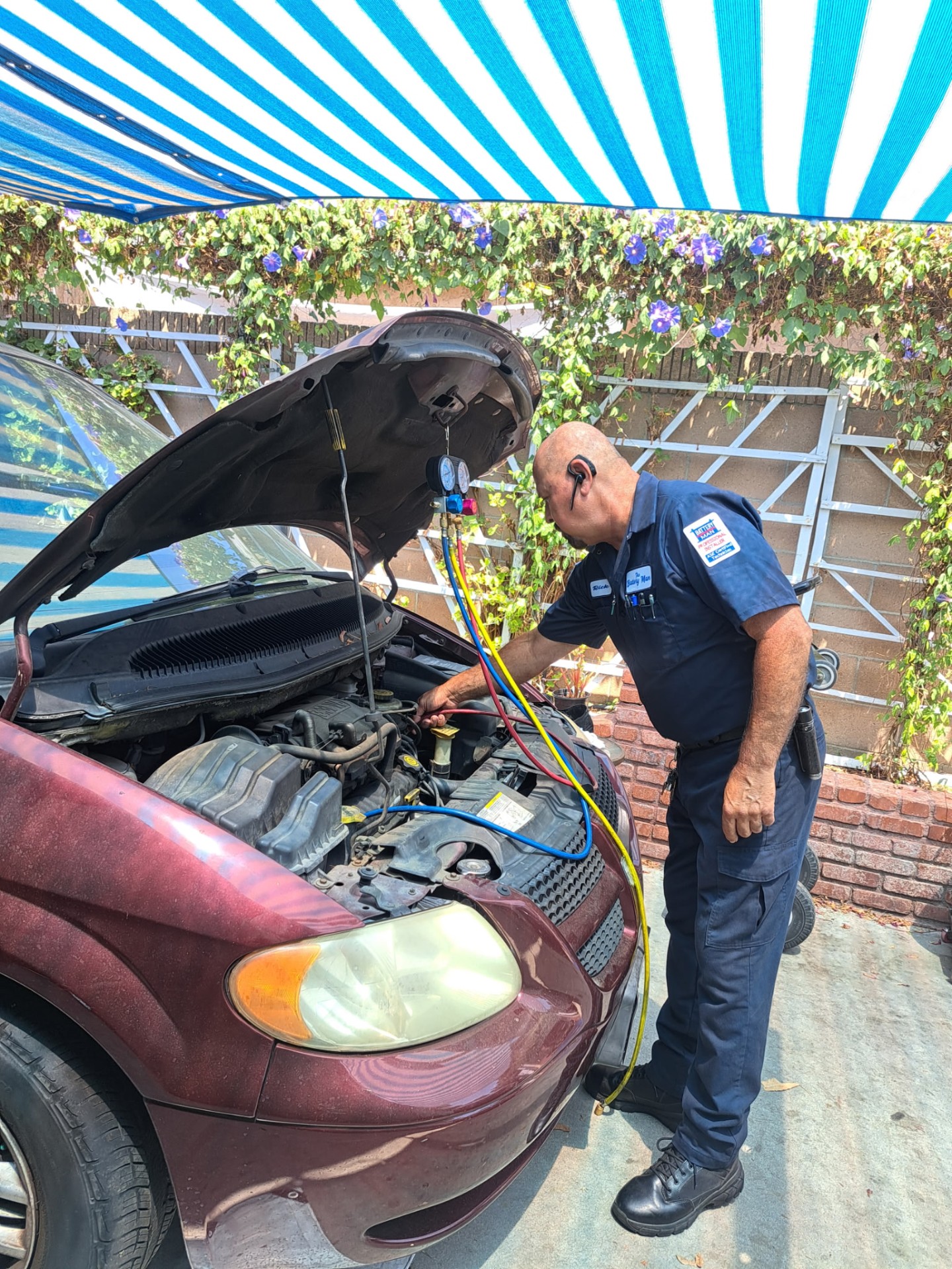 Rick connecting A/C manifold gauges to a minivan engine bay